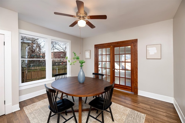 dining room with ceiling fan, wood finished floors, and baseboards