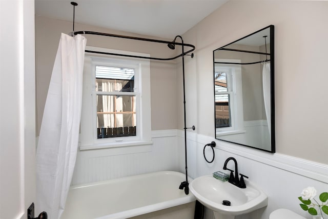 bathroom featuring wainscoting and a sink