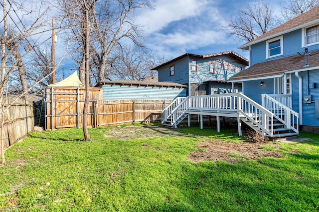 view of yard with a fenced backyard, stairway, and a wooden deck