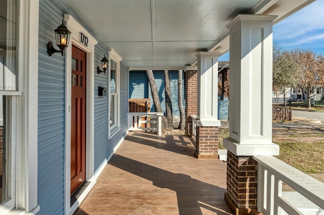 wooden terrace with a porch