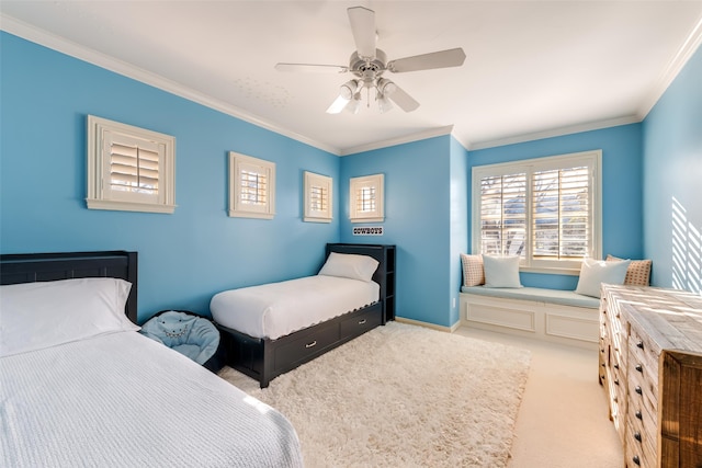 bedroom with ornamental molding, light colored carpet, baseboards, and a ceiling fan