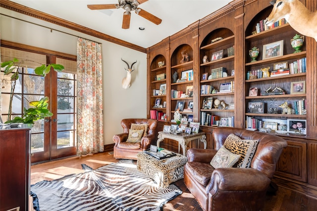 sitting room featuring ceiling fan, french doors, wood finished floors, and crown molding