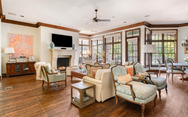 living room featuring a warm lit fireplace, visible vents, wood finished floors, and ornamental molding