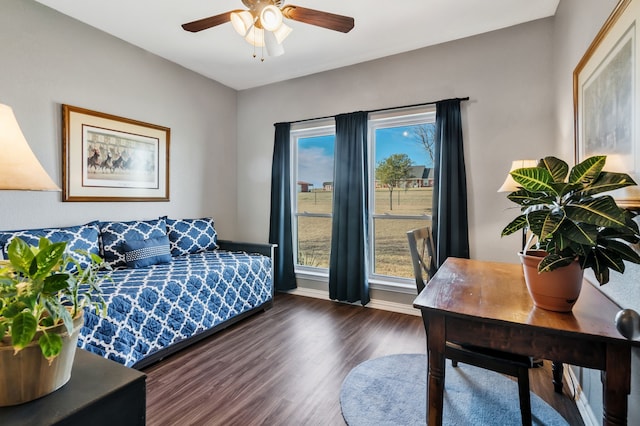 bedroom featuring a ceiling fan, baseboards, and wood finished floors