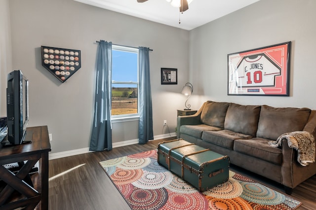 living area featuring ceiling fan, baseboards, and wood finished floors