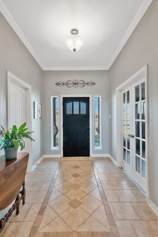 foyer entrance with french doors, crown molding, and baseboards