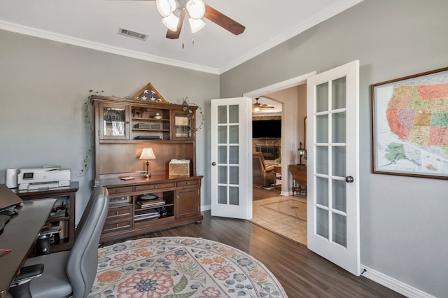 office area featuring french doors, dark wood-style flooring, crown molding, visible vents, and a ceiling fan