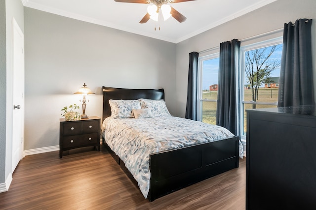 bedroom featuring ornamental molding, ceiling fan, baseboards, and wood finished floors