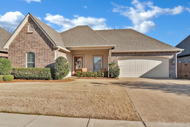 view of front of property with a garage, driveway, and brick siding