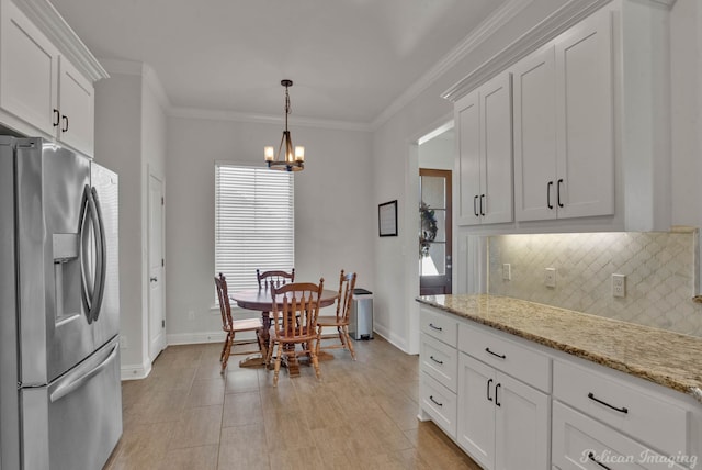 kitchen featuring a notable chandelier, white cabinets, ornamental molding, stainless steel fridge with ice dispenser, and tasteful backsplash