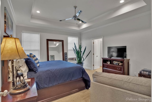 carpeted bedroom with baseboards, a tray ceiling, crown molding, and recessed lighting