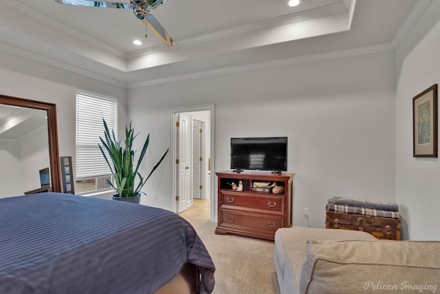 bedroom featuring light carpet, a tray ceiling, recessed lighting, and crown molding