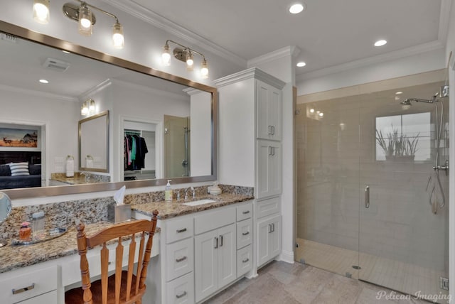 full bathroom with a shower stall, visible vents, crown molding, and vanity