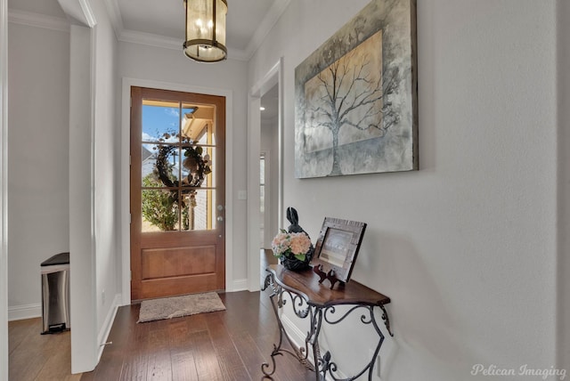 entryway featuring dark wood-style floors, baseboards, and crown molding