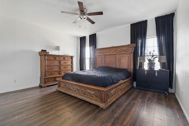 bedroom featuring a textured ceiling, dark wood-style flooring, a ceiling fan, and baseboards