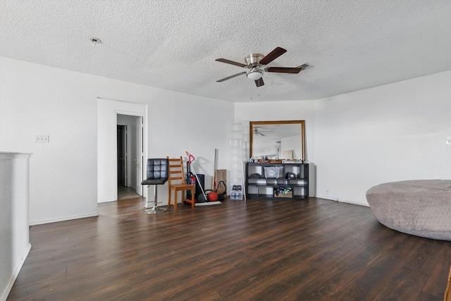 sitting room featuring visible vents, ceiling fan, a textured ceiling, and wood finished floors