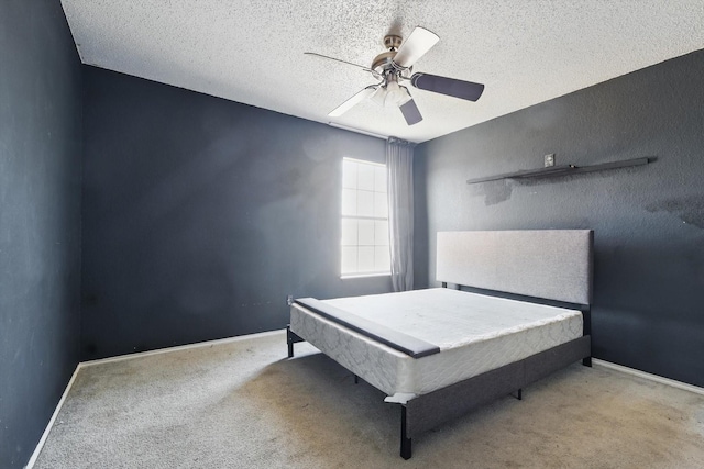 bedroom with carpet flooring, a textured ceiling, and baseboards