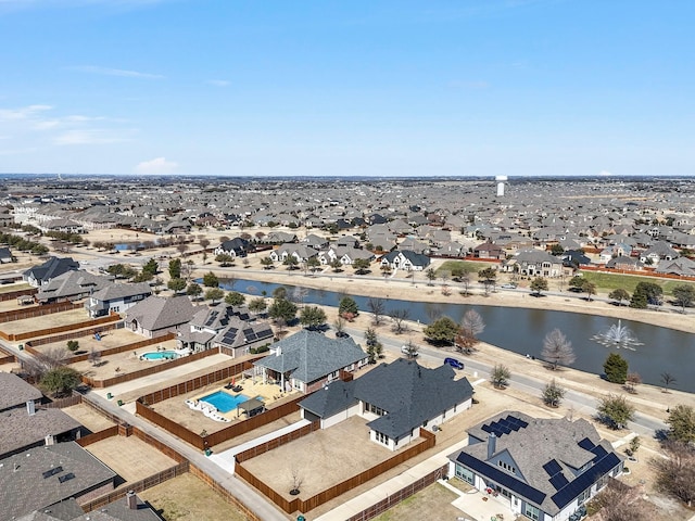 drone / aerial view with a water view and a residential view