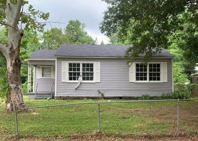 view of front of home featuring a front yard and fence private yard