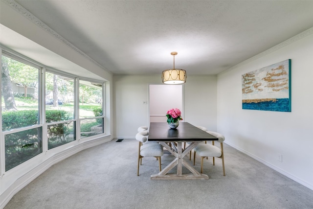 dining room with carpet, visible vents, a textured ceiling, and baseboards