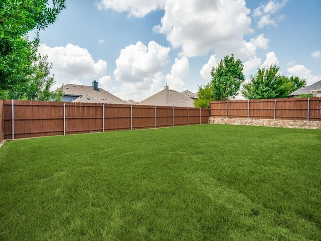 view of yard with a fenced backyard