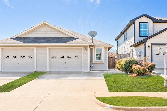 view of front of house featuring a garage, fence, concrete driveway, and roof with shingles