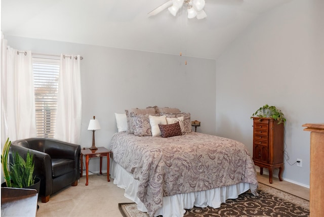 carpeted bedroom with a ceiling fan, vaulted ceiling, and baseboards