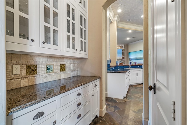 885 Vz County Road 2513, Canton, TX 75103 - bar area featuring arched walkways, stone tile flooring, tasteful backsplash, ornamental molding, and a sink