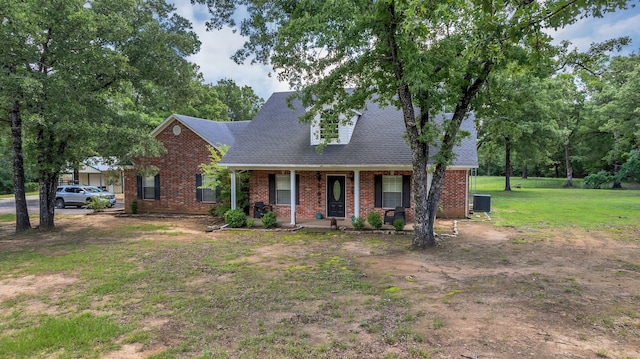 2113 Vz County Road 3710, Edgewood, TX 75117 - cape cod-style house with brick siding, a porch, central AC unit, a front lawn, and a shingled roof