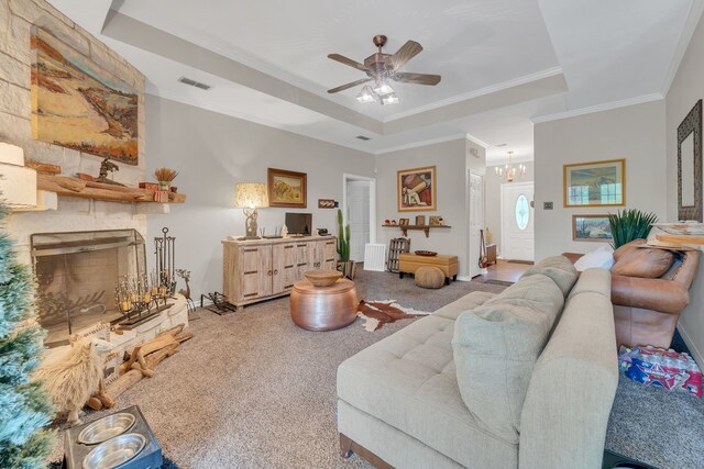 2113 Vz County Road 3710, Edgewood, TX 75117 - living area featuring ornamental molding, a tray ceiling, carpet flooring, ceiling fan, and a stone fireplace