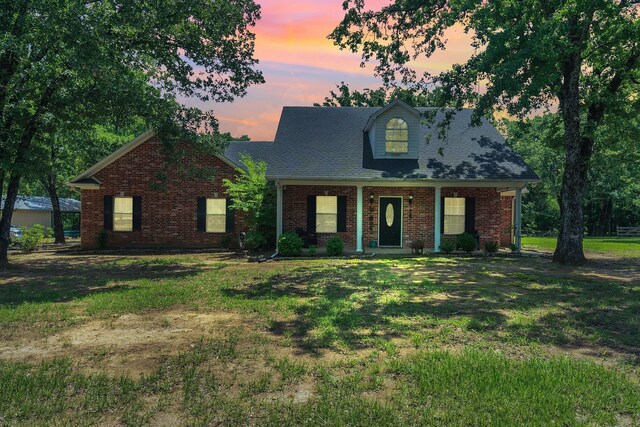 2113 Vz County Road 3710, Edgewood, TX 75117 - cape cod house with brick siding, covered porch, a shingled roof, and a front lawn