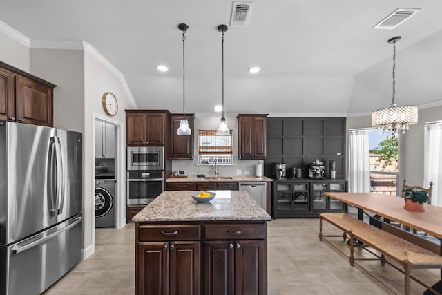 kitchen with a sink, visible vents, appliances with stainless steel finishes, and crown molding