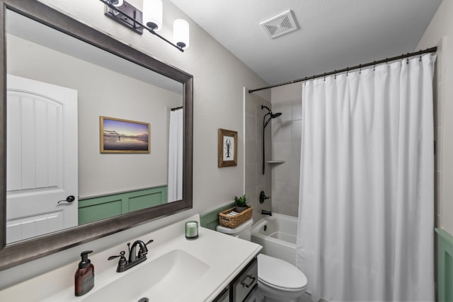 bathroom with visible vents, shower / tub combo with curtain, vanity, and toilet