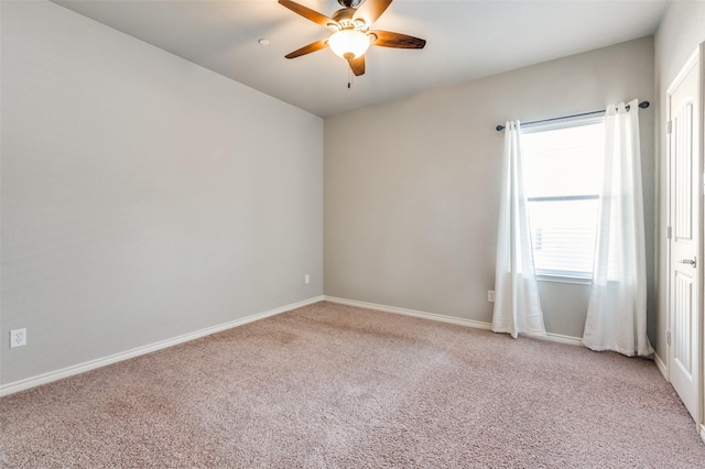 spare room with carpet flooring, ceiling fan, and baseboards