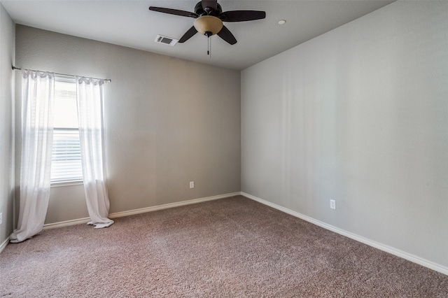 spare room featuring a ceiling fan, carpet flooring, visible vents, and baseboards