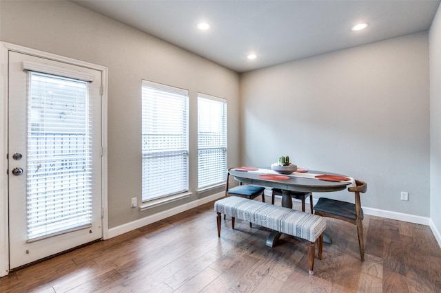 dining room with recessed lighting, baseboards, and wood finished floors