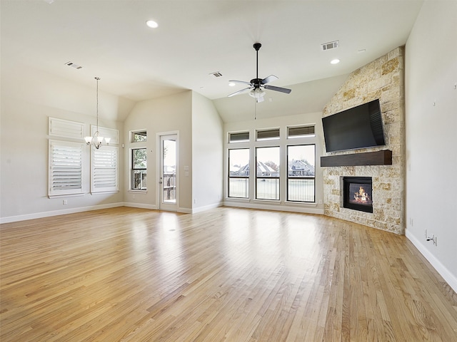 unfurnished living room featuring plenty of natural light, light wood-type flooring, a fireplace, and visible vents