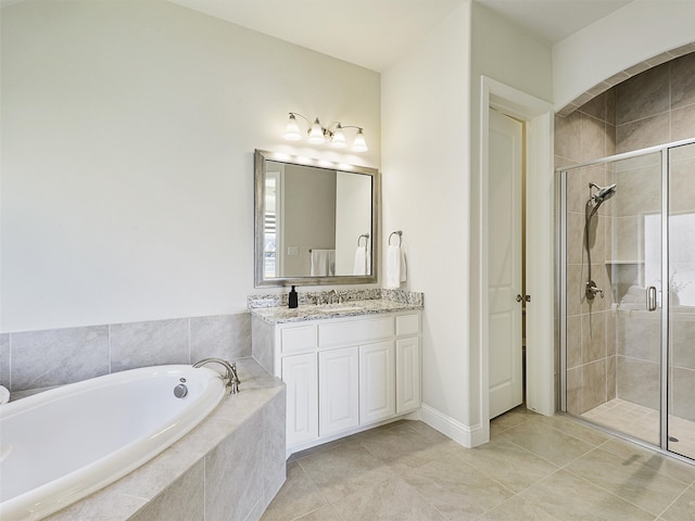 full bath featuring a garden tub, a shower stall, tile patterned floors, and vanity