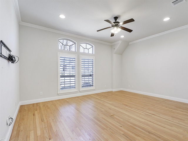 spare room featuring light wood-style flooring, baseboards, a ceiling fan, and ornamental molding