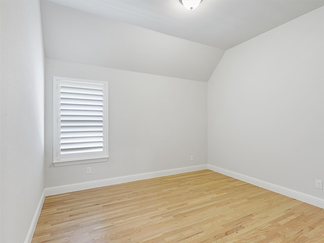 bonus room featuring vaulted ceiling, baseboards, and wood finished floors