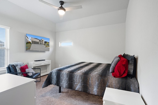 carpeted bedroom with ceiling fan and multiple windows