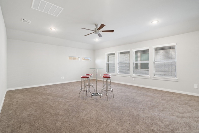 interior space featuring carpet floors, recessed lighting, visible vents, ceiling fan, and baseboards