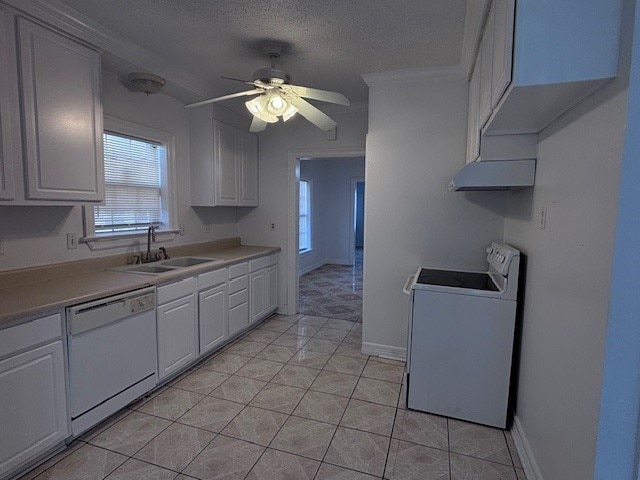 kitchen with dishwasher, stove, light countertops, a textured ceiling, and a sink