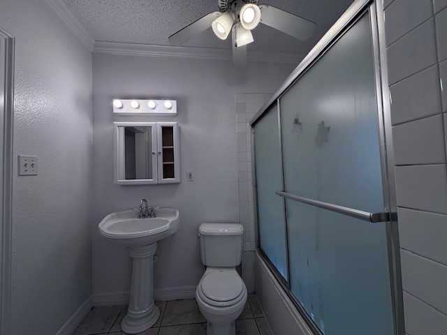 full bathroom with a textured ceiling, ceiling fan, tile patterned flooring, toilet, and crown molding