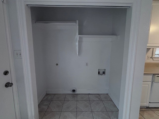 laundry room featuring washer hookup, hookup for an electric dryer, baseboards, and light tile patterned floors