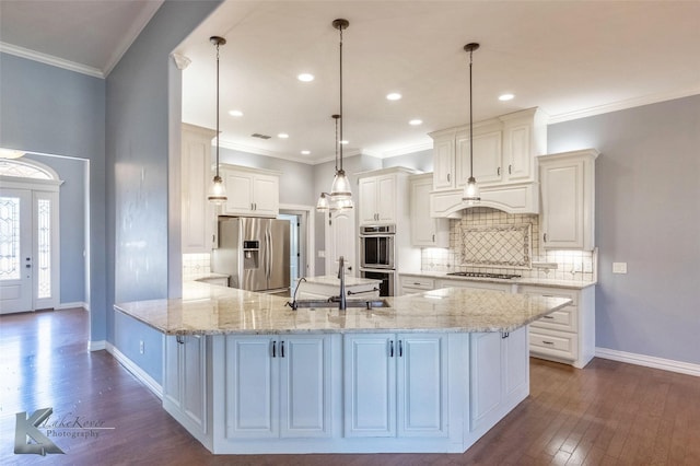 kitchen with dark wood-type flooring, ornamental molding, a sink, appliances with stainless steel finishes, and custom exhaust hood