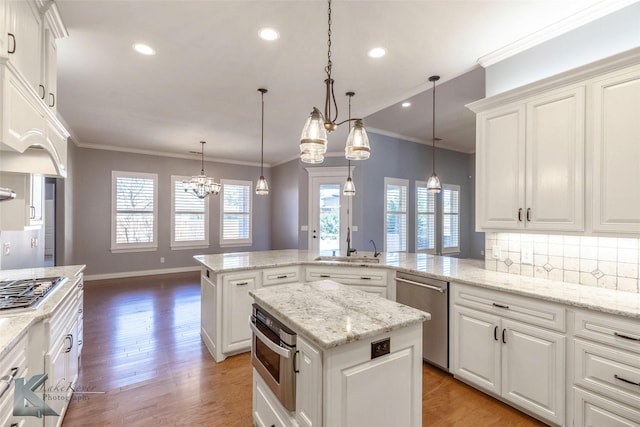 kitchen featuring decorative backsplash, appliances with stainless steel finishes, white cabinetry, crown molding, and light wood-type flooring