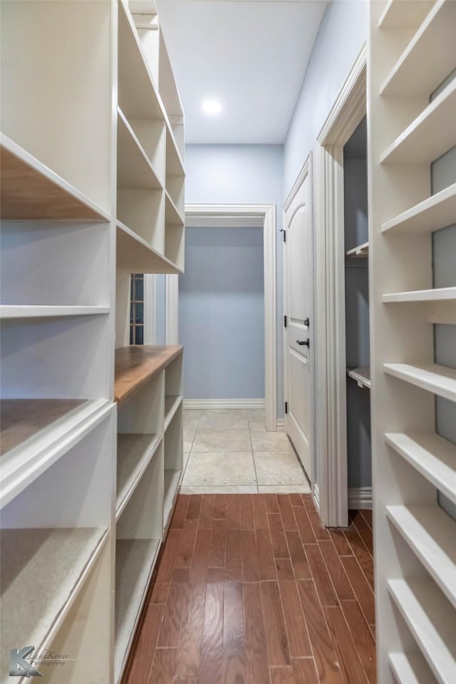 spacious closet with dark wood-type flooring