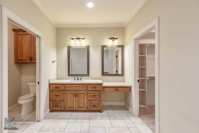 bathroom featuring tile patterned flooring, toilet, vanity, and crown molding