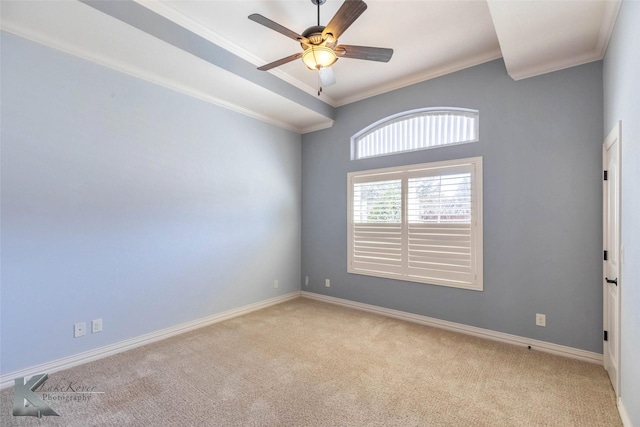 spare room featuring baseboards, light carpet, ceiling fan, and crown molding